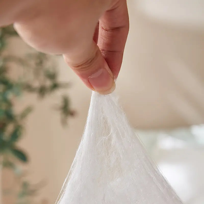 <p>Each comforter is layered by hand in a cross-grid pattern. This traditional technique creates thousands of tiny air pockets for maximum loft and thermal regulation.</p>